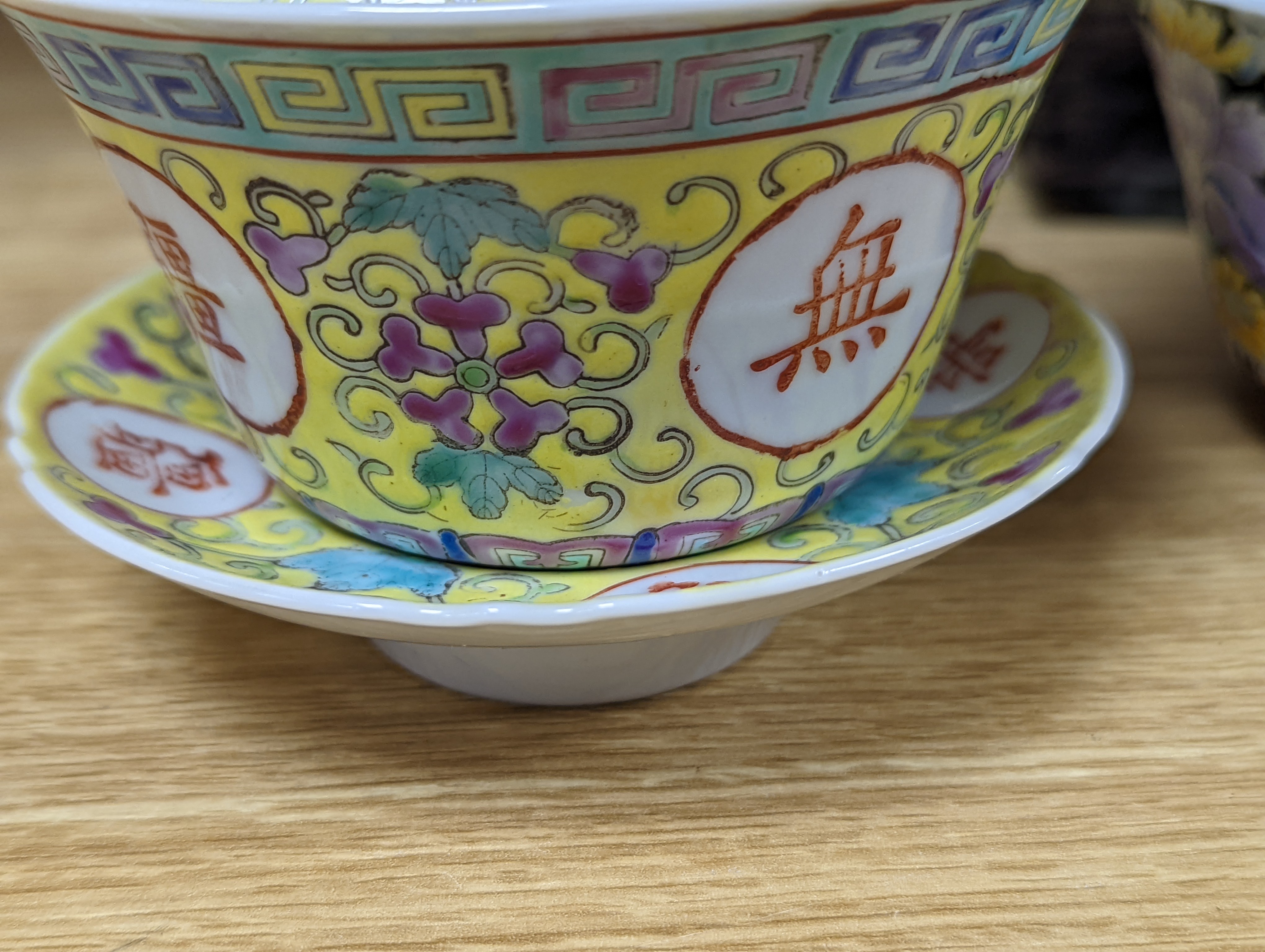 A pair of Chinese enamelled porcelain rice bowls, covers and stands and an odd bowl